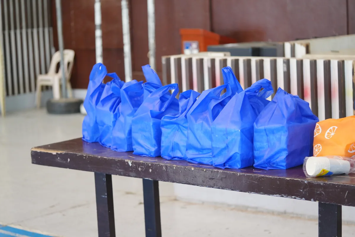 Volunteers serve warm meals to community members